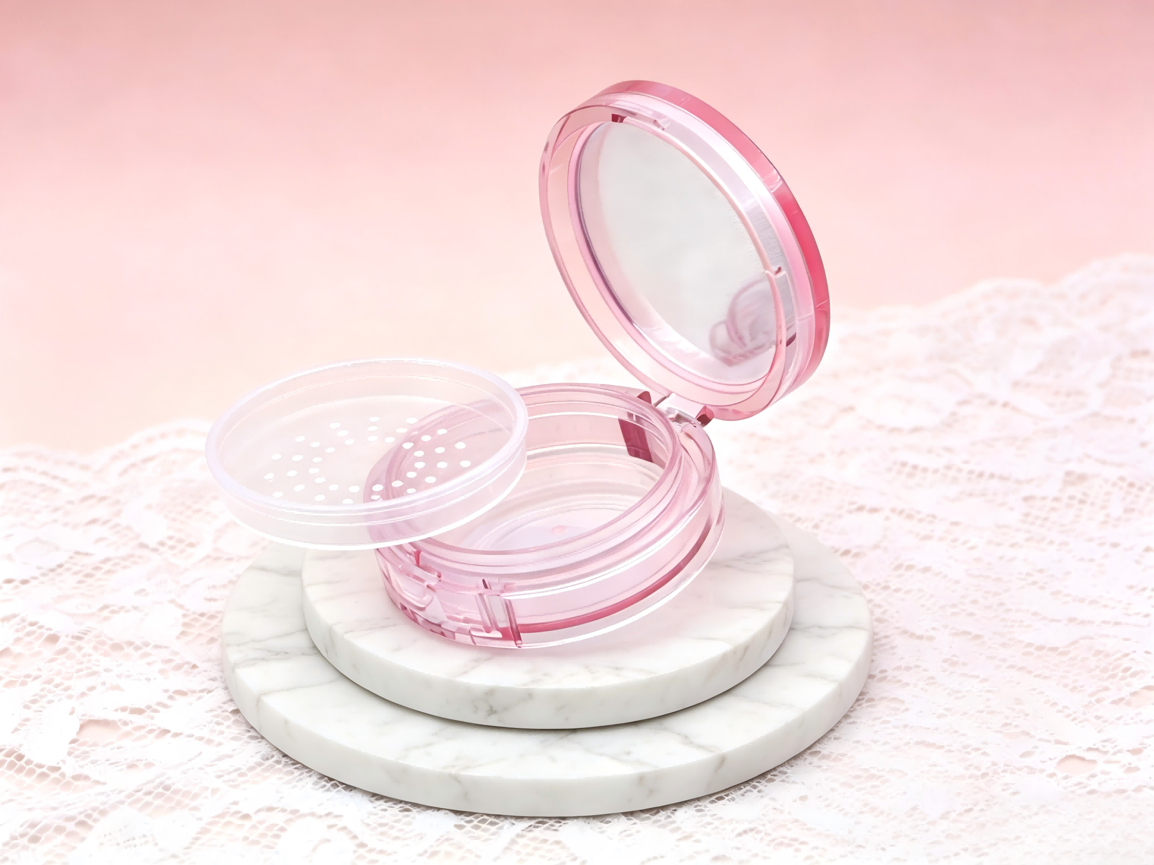 Pink transparent round loose powder case with sifter mesh and built-in mirror for cosmetic powder.